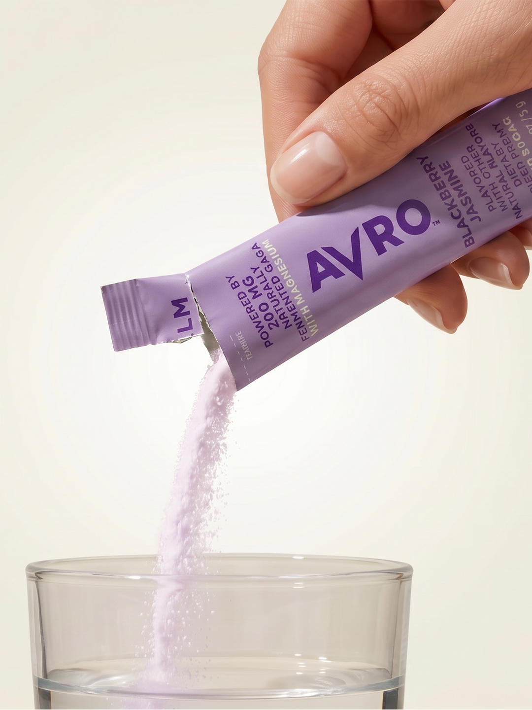 Pouring an AVRO Calm stick into a glass of water